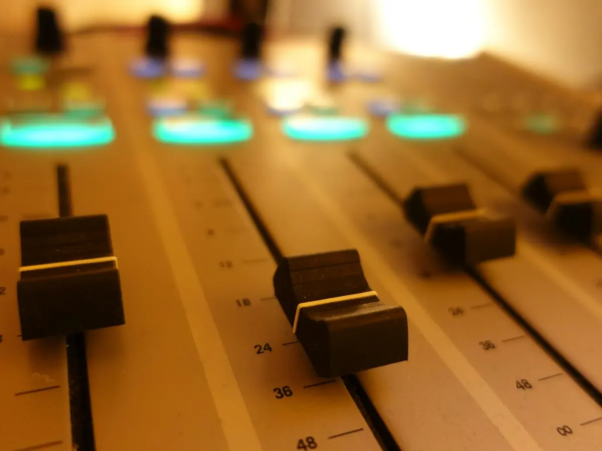 Close-up of the faders on a mixing desk