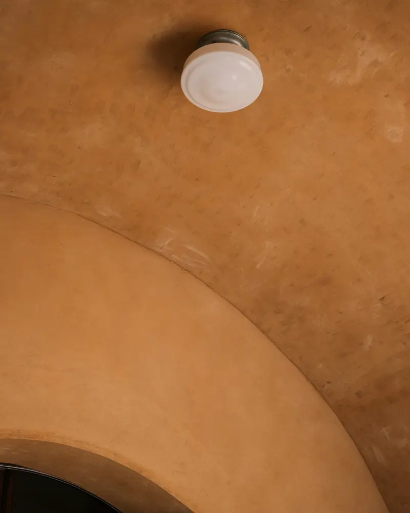 Ochre plaster on a vaulted ceiling and archway