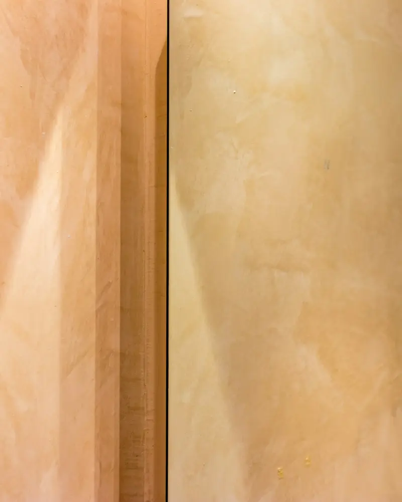 Curved walls in warm polished plaster catching side light